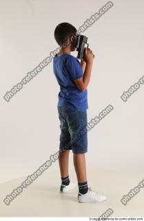 TIMBO STANDING POSE WITH GUN